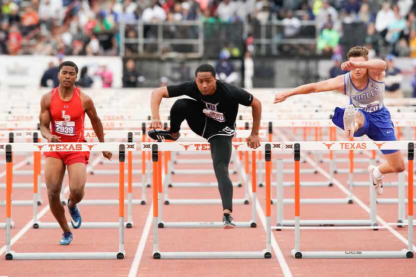 Terry Smith of Frisco Independence (center) clears the final hurdle to win the Class 5A boys...