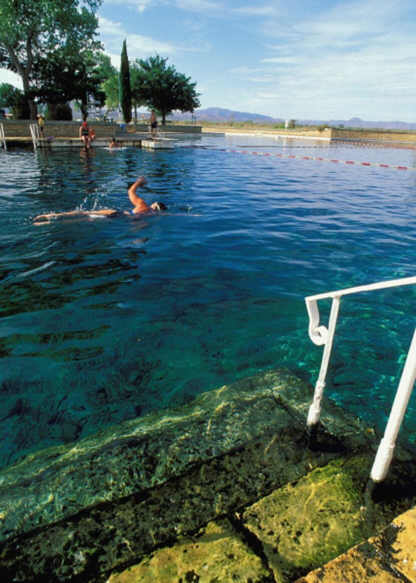 The clear, cool, spring-fed pool at Balmorhea State Park is populated with fish, turtles,...