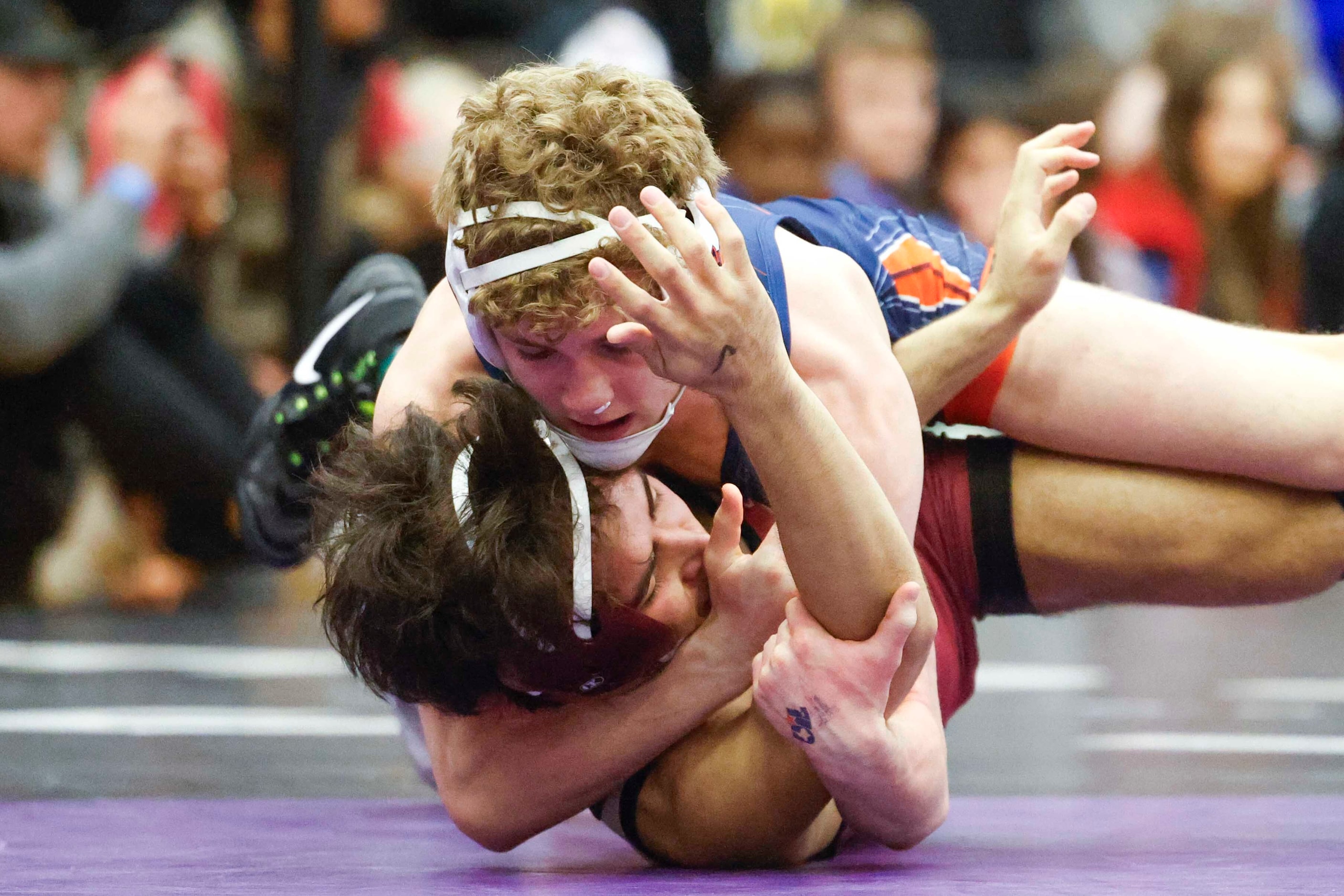 Michael Brennan of Frisco Wakeland wrestles against  Kai Mcdermott of Frisco Heritage...