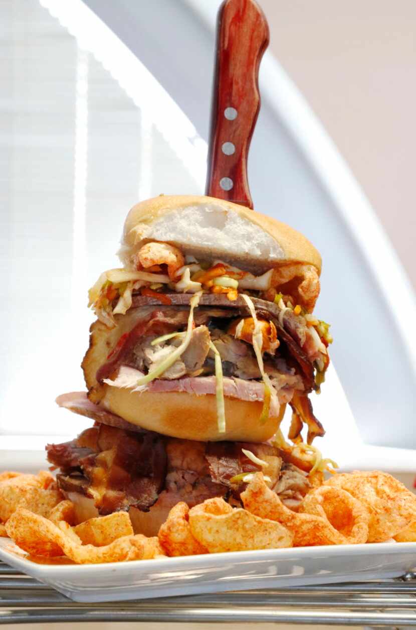 The Wicked Pig is a Hawaiian roll layered with pulled pork, bacon, sausage, prosciutto and...