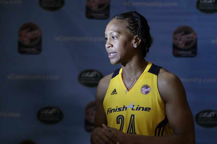 Indiana Fever's Tamika Catchings responds to questions from the media during media day...