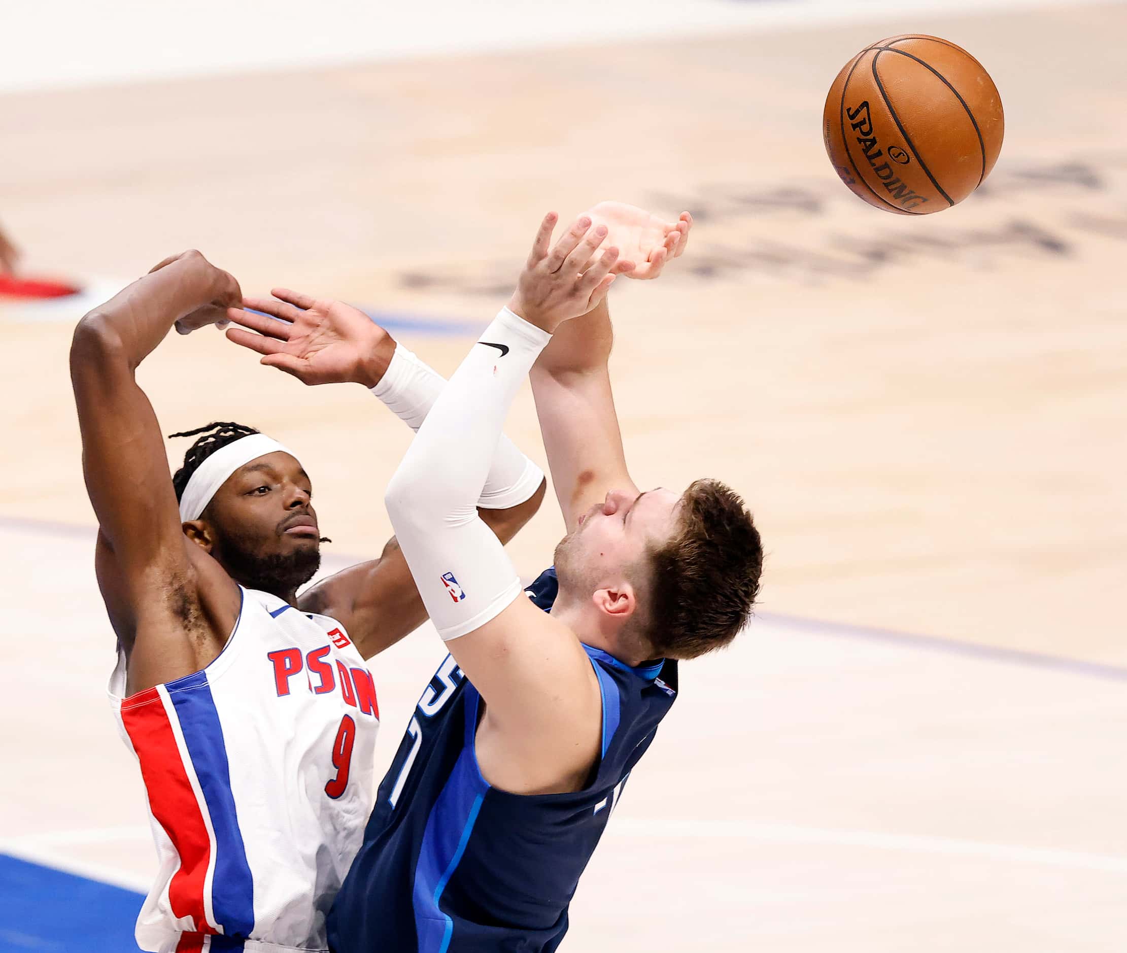 Dallas Mavericks guard Luka Doncic (77) has his shot knocked away by Detroit Pistons forward...