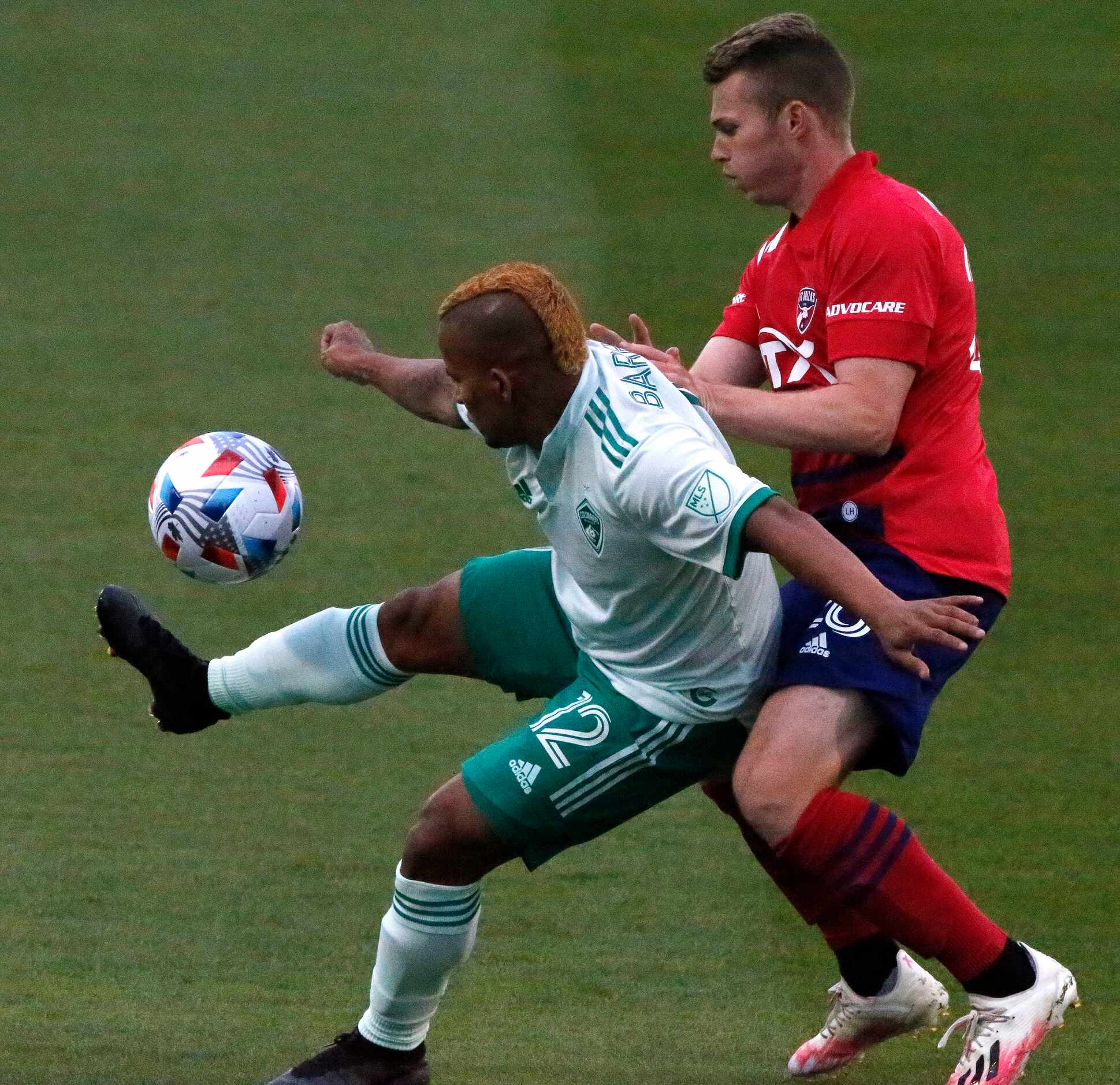 FC Dallas defender John Nelson (26) is shielded from the ball by Colorado Rapids forward...
