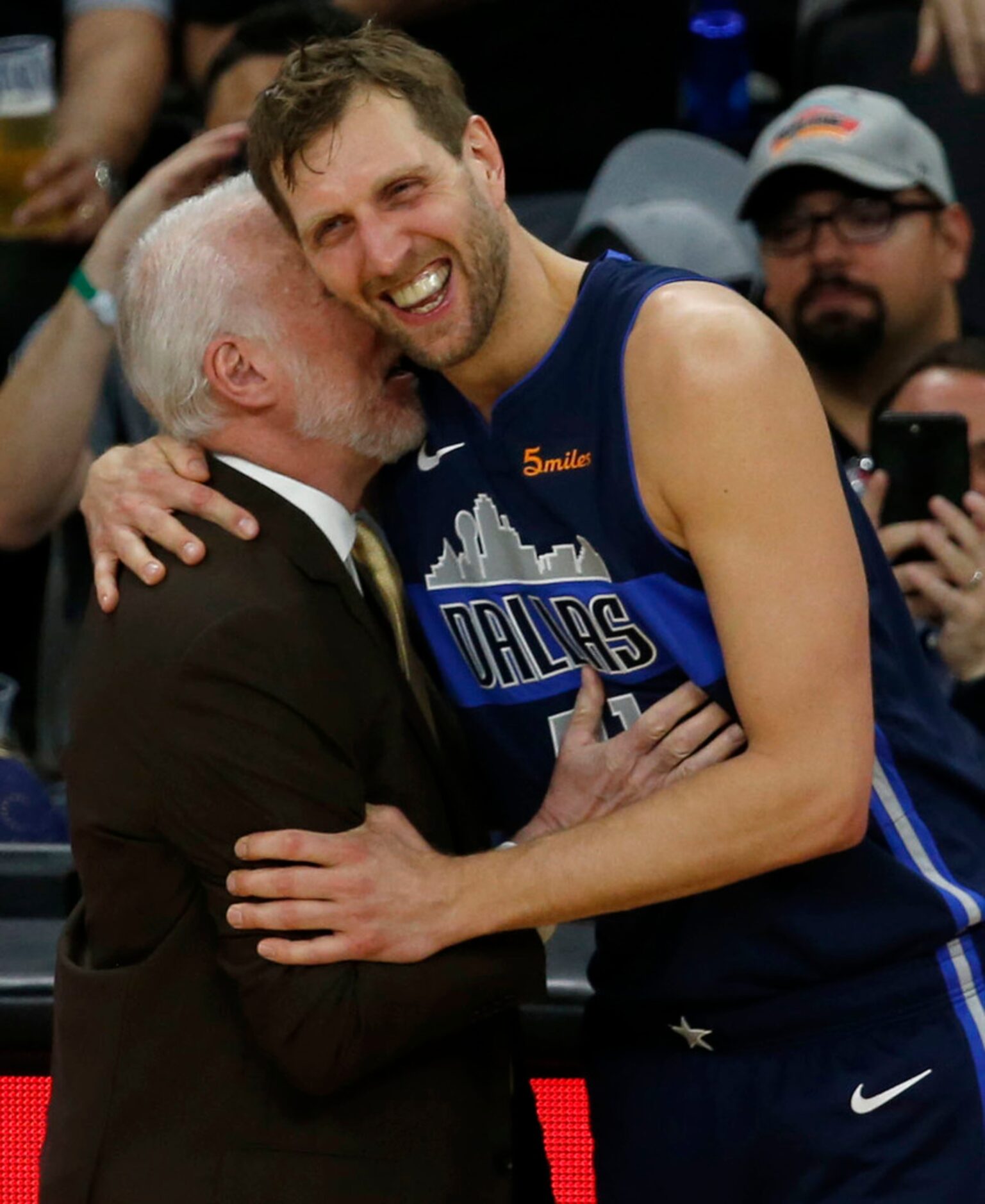 San Antonio Spurs head coach Gregg Popovich talks with Dallas Mavericks forward Dirk...