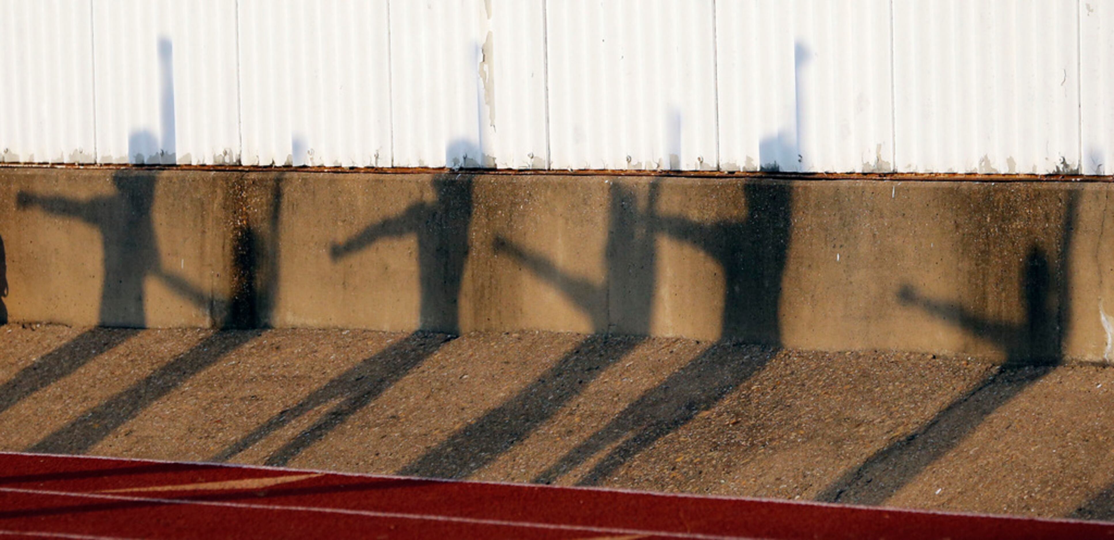 The Irving high cheerleader's shadows workout before the start of their team's during high...