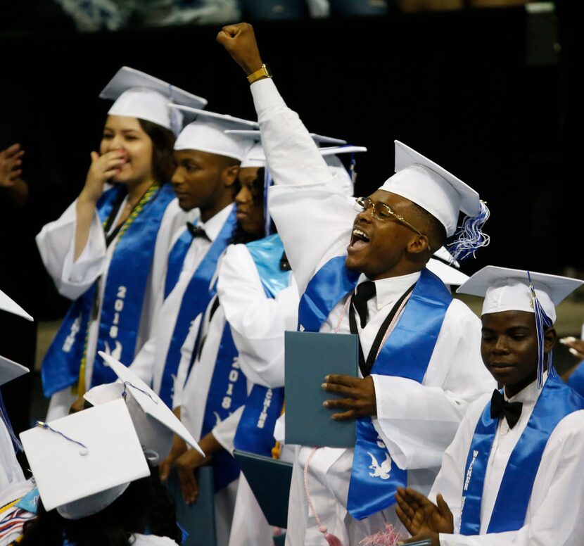 A graduate pumps his fist during the Wilmer-Hutchins High School graduation at Ellis Davis...