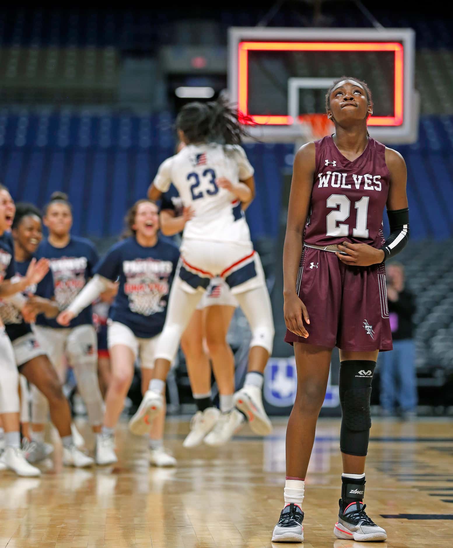Mansfield Timberview Forward Stephanie Mosley #21 looks up as SA Veterans celebrates in...