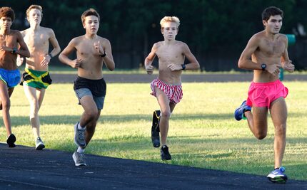 Southlake Carroll High School cross-country runner Chris Tracht, 15, second from right,...