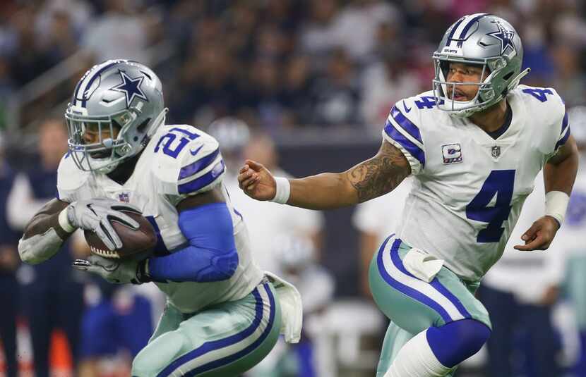 Dallas Cowboys quarterback Dak Prescott (4) hands off to running back Ezekiel Elliott (21)...