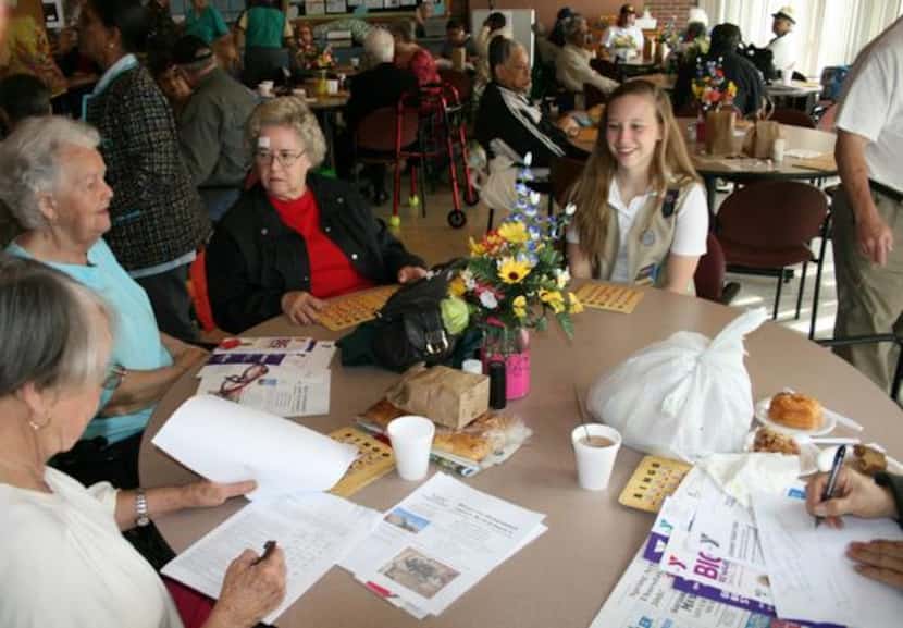 Holly Ingram, 14, enjoys a game of bingo at the Garland Senior Center with (from left) Peggy...
