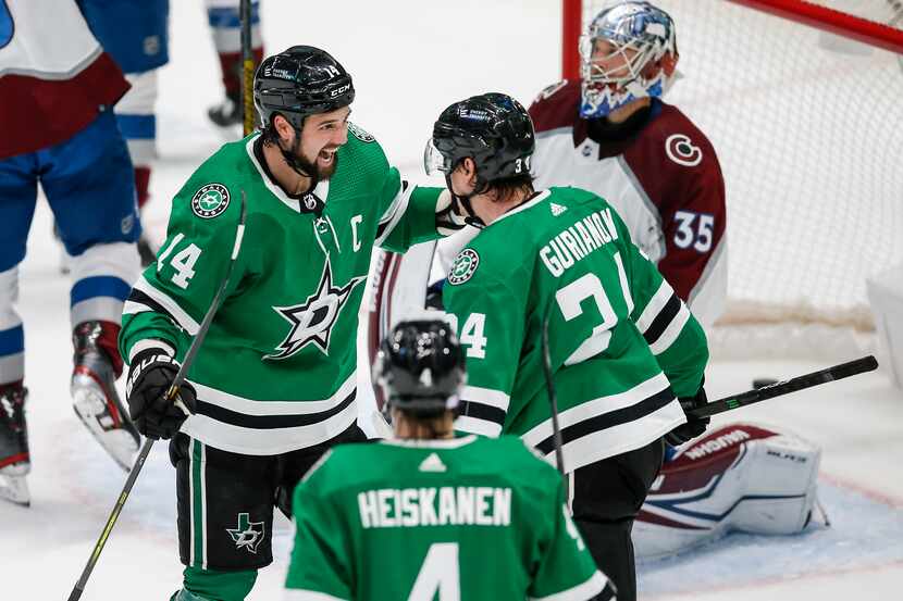 Dallas Stars forward Denis Gurianov (34) is congratulated by forward Jamie Benn (14) after...