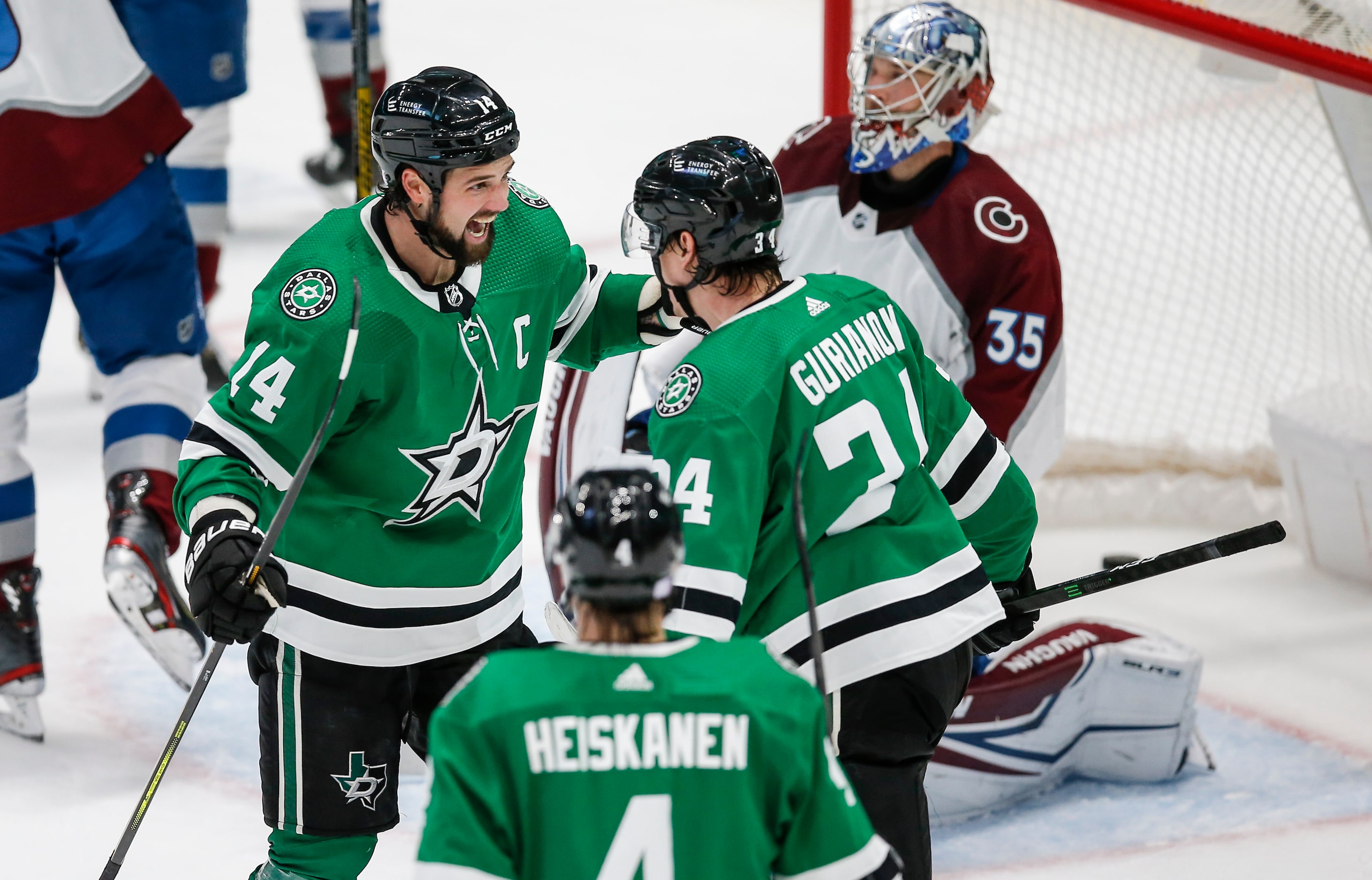 Dallas Stars forward Denis Gurianov (34) is congratulated by forward Jamie Benn (14) after...