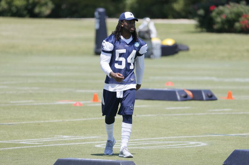 Dallas Cowboys linebacker Jaylon Smith watches the team work out during an NFL football...
