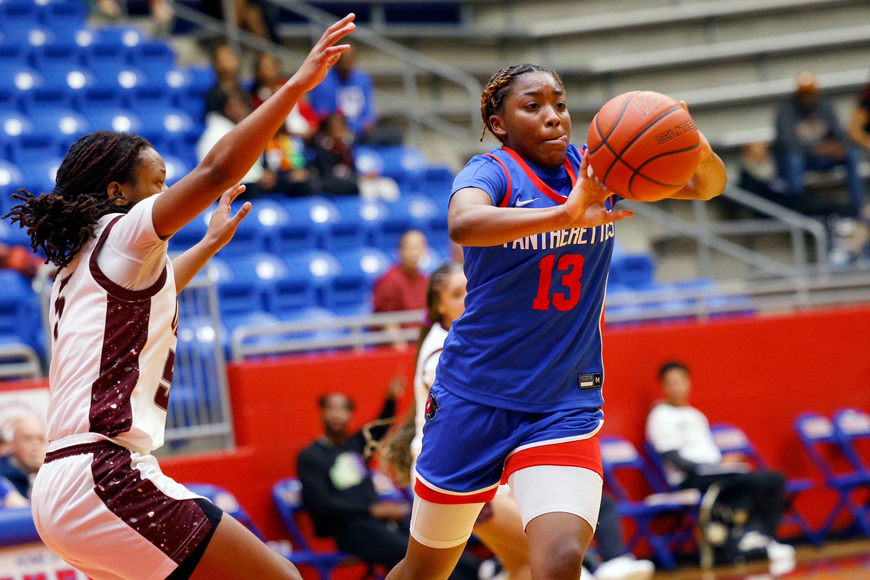 Duncanville's Samari Holmen (13) passes a ball as Pearland's Tycee Thibeaux (5) tries to...