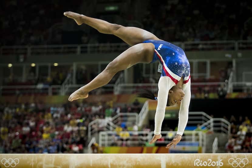 Simone Biles of the United States competes on the balance beam during the women's gymnastics...