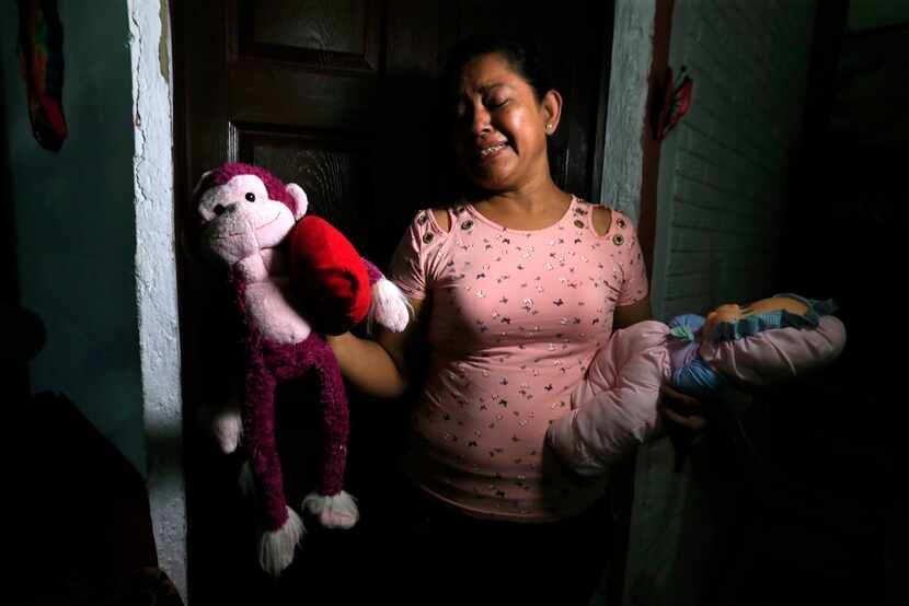 Rosa Ramirez sobs as she shows journalists toys that belonged to her nearly 2-year-old...