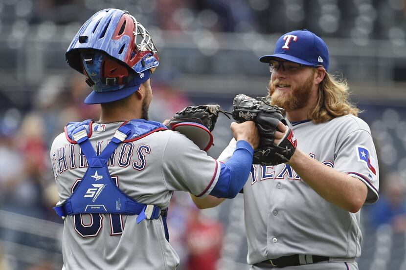 SAN DIEGO, CA - MAY 9: A.J. Griffin #64 of the Texas Rangers, right, is congratulated by...