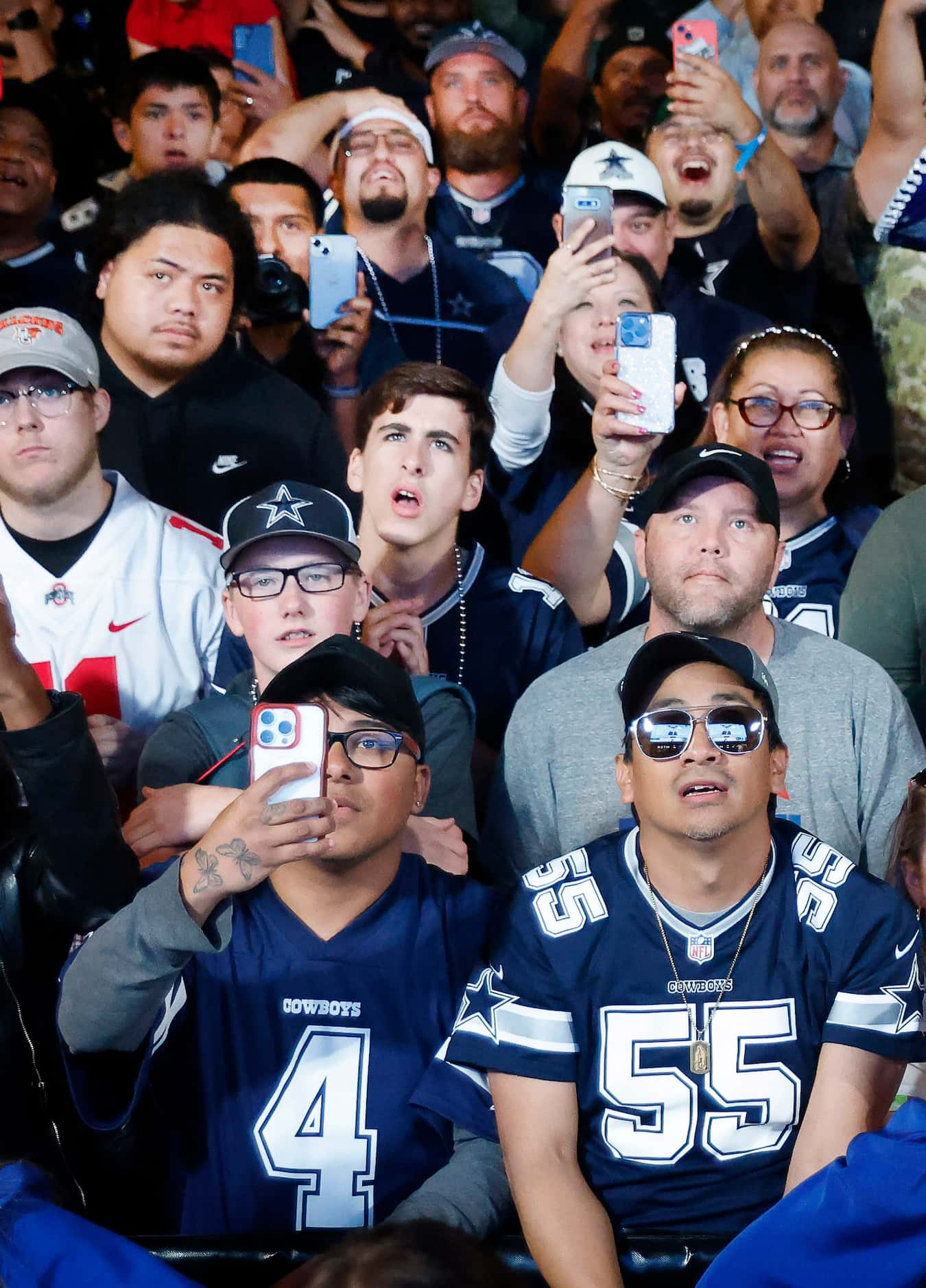 Dallas Cowboys fans cheer the teams first round pick in the NFL Draft during a draft party...