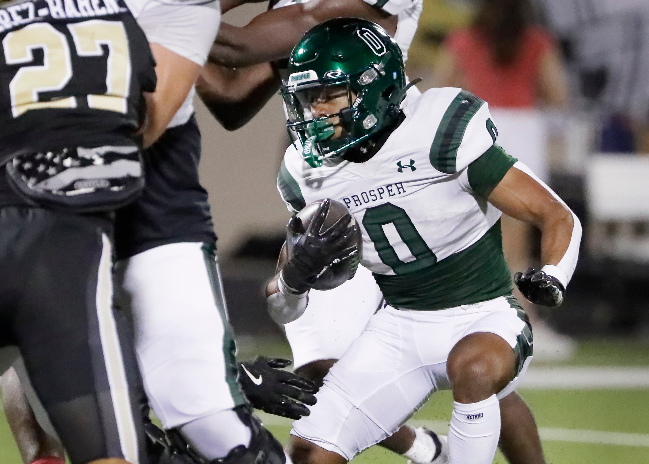 Prosper High School running back Leo Anguianjo (0) looks for room to run during the first...