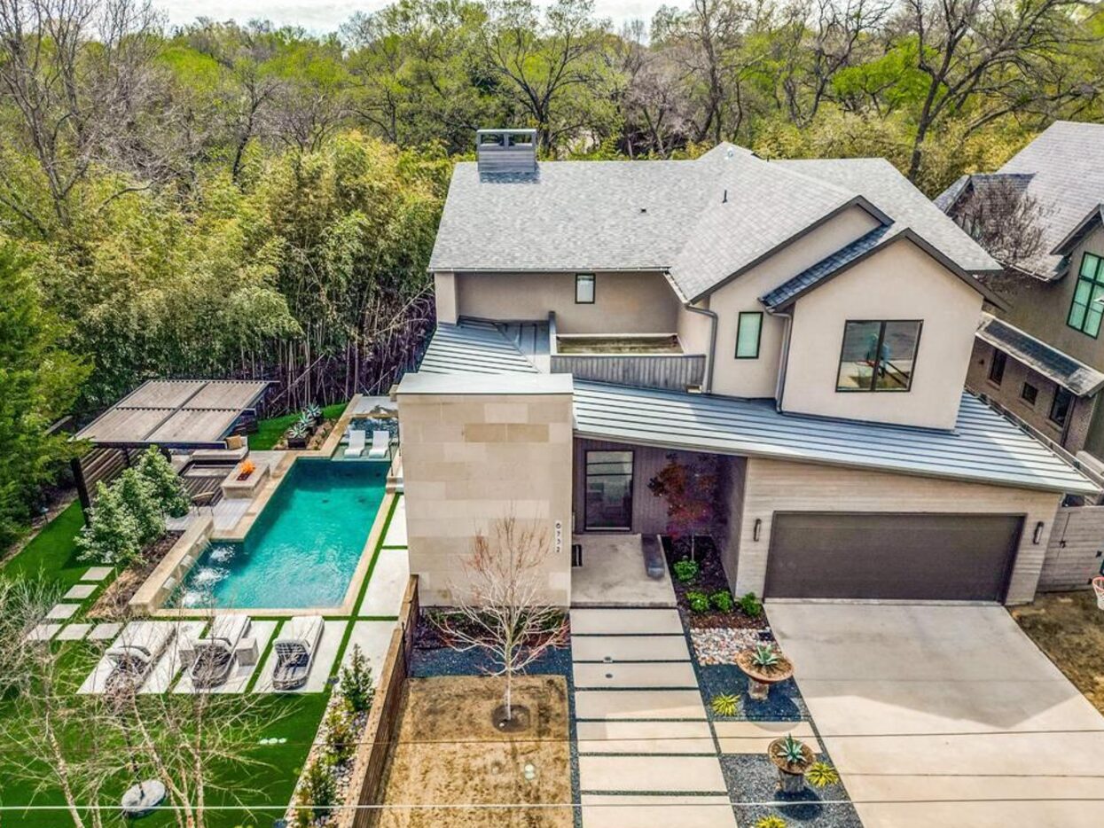 Home with pool surrounded by trees