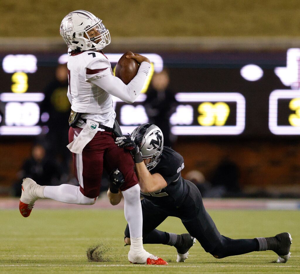 Arlington Martin linebacker Keller Webb (22) tackles Lewisville quarterback Ethan Terrell...