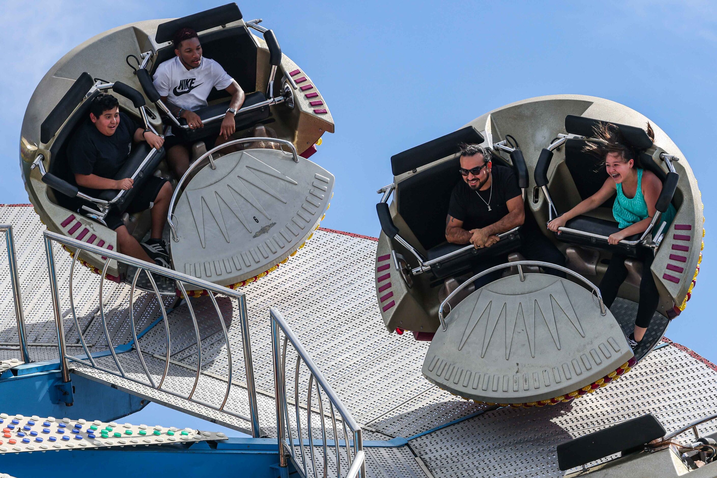 People aboard a carnival ride at the State Fair of Texas during its opening day in Dallas on...