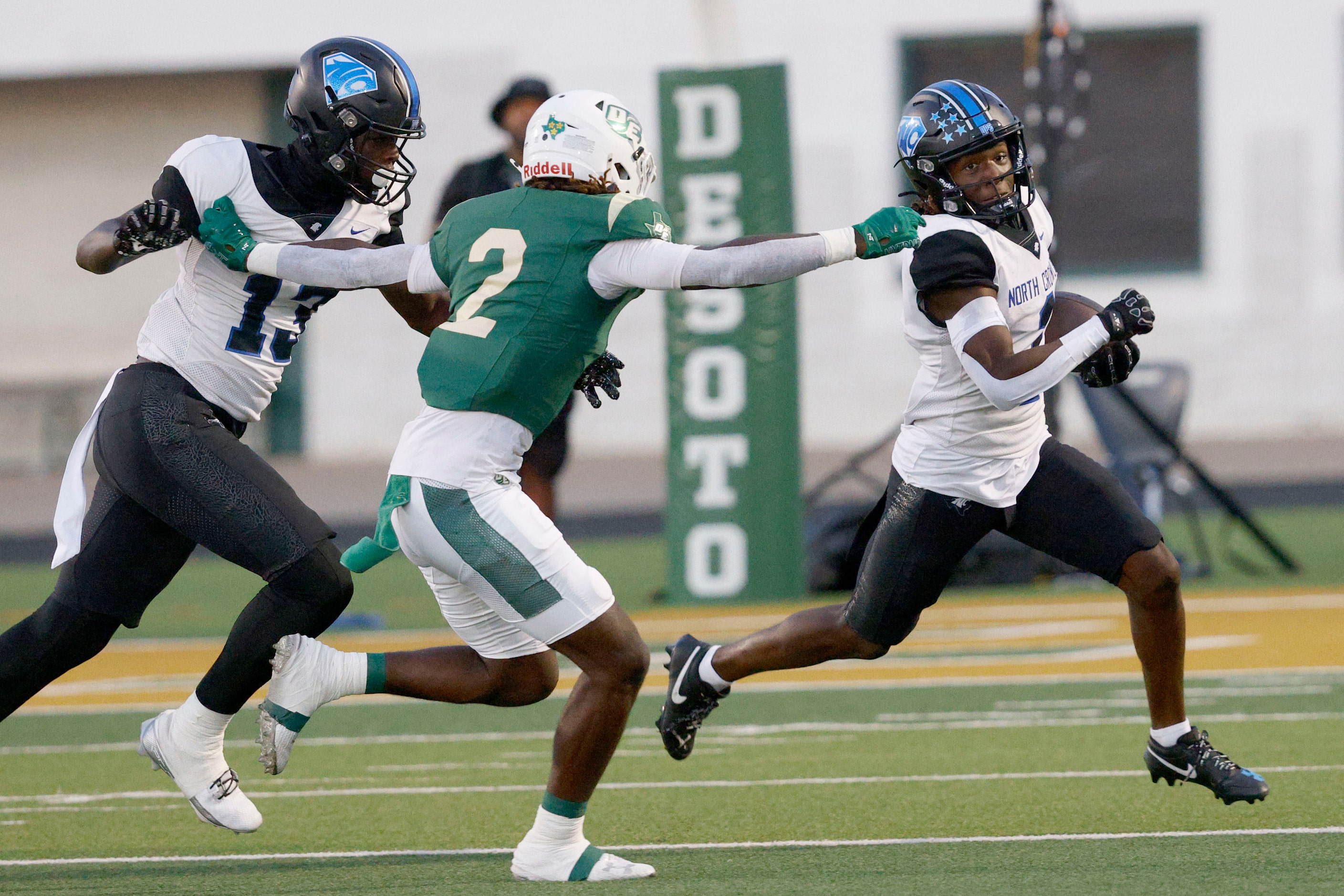 North Crowley's Cornelius Warren (1) carries the ball as DeSoto's Sael Reyes (2) tries to...