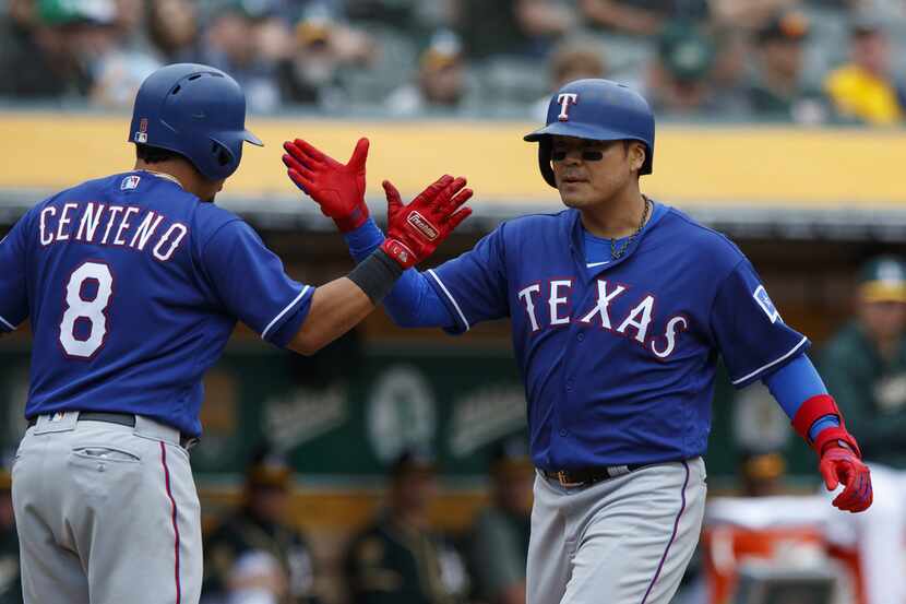 OAKLAND, CA - APRIL 05:  Shin-Soo Choo #17 of the Texas Rangers is congratulated by Juan...