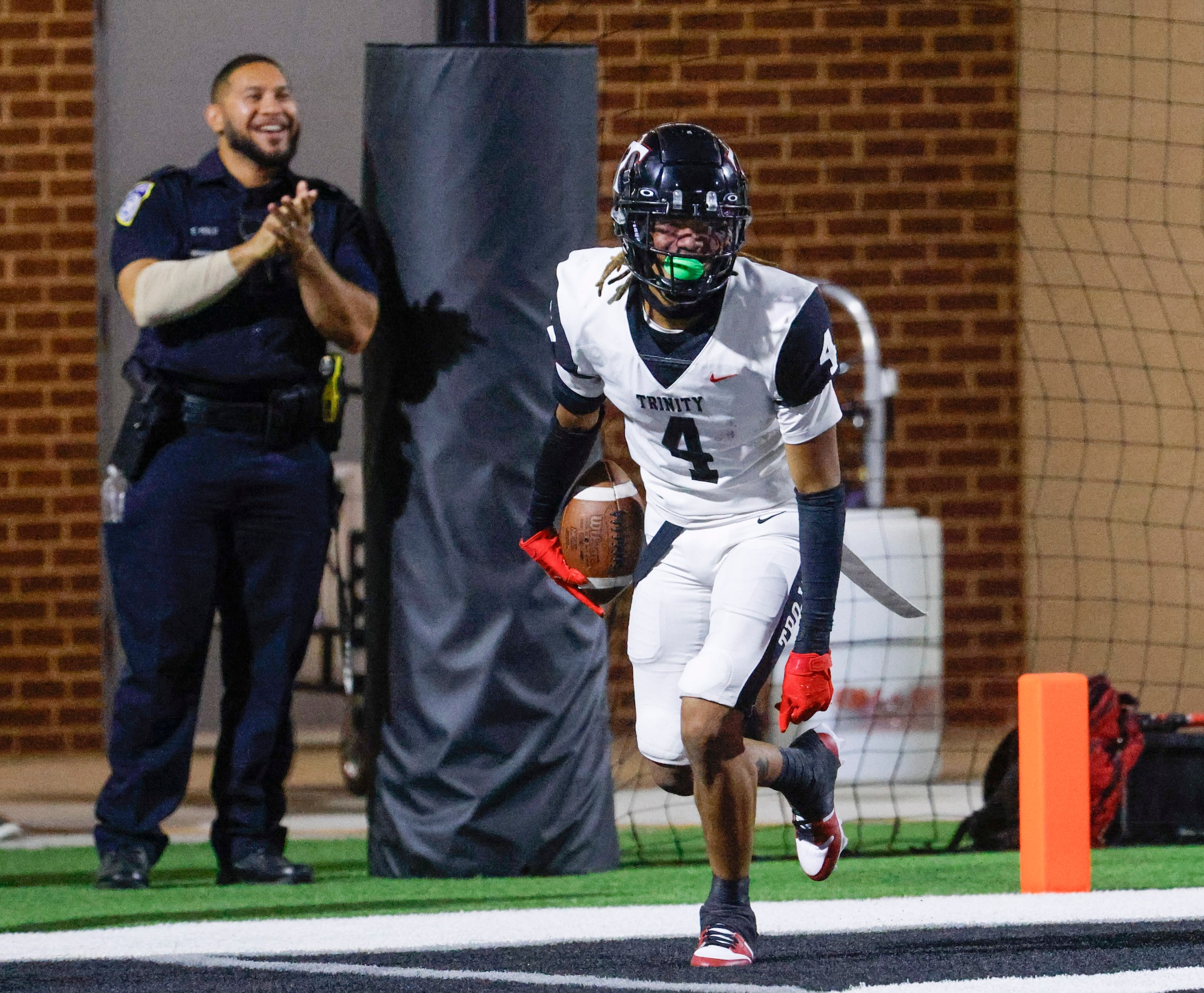 Trinity High’s Jarvis Heimuli celebrates after scoring a touchdown against Crowley High...