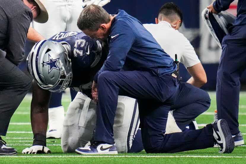 Dallas Cowboys offensive tackle Tyler Smith (73) is helped up after being injured during the...