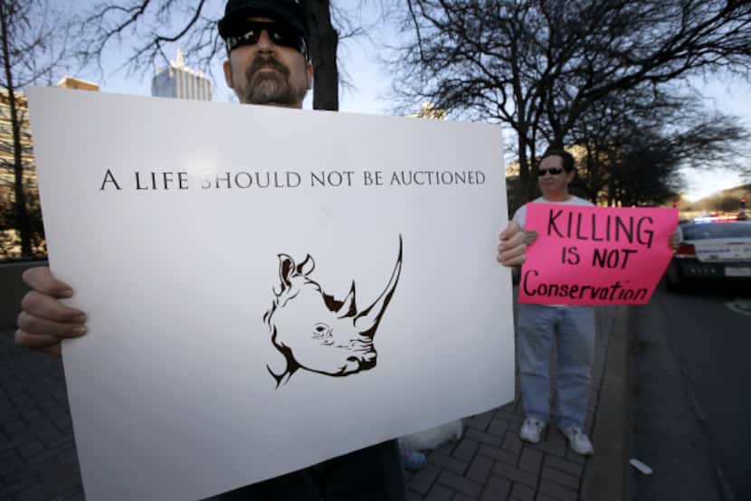 Bob Fretwell of Mesquite holds a sign protesting outside the Dallas Convention Center.