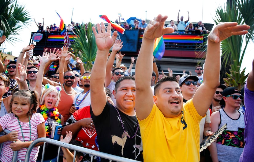 People along the route yell for beads during the Texas Freedom Parade.