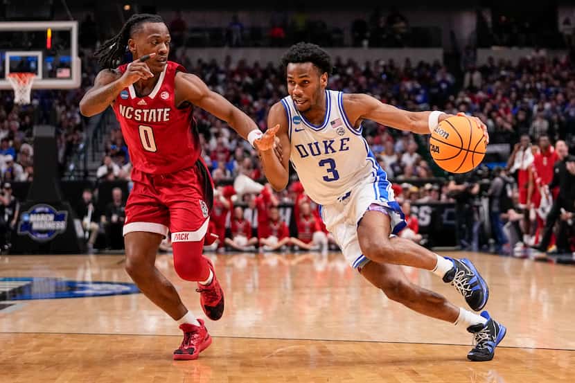 Duke's Jeremy Roach (3) drives against North Carolina State's DJ Horne (0) during the second...