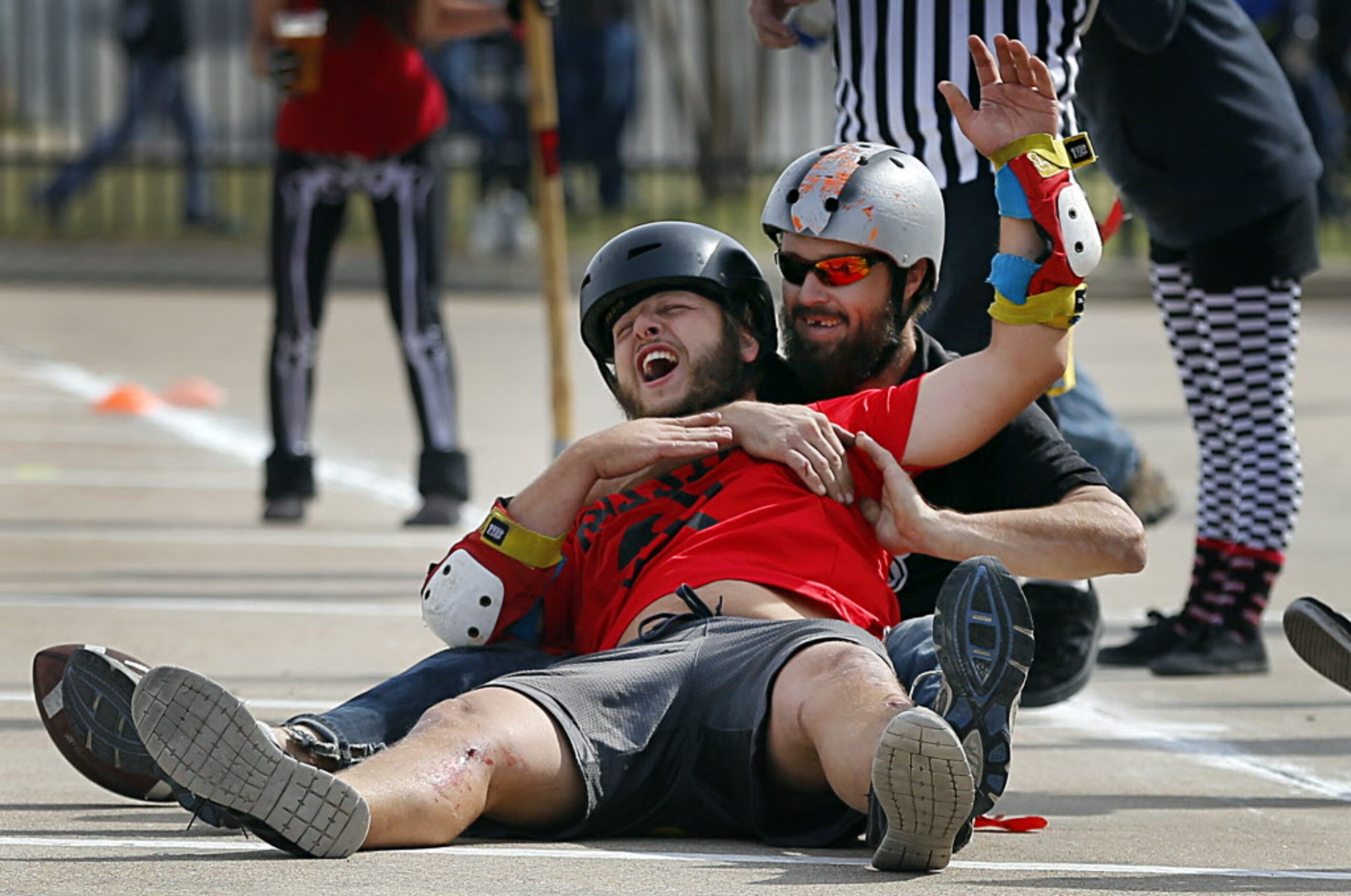 Team Russia's Dan Walter laughs after Uni Billies Chance 'Crazy Horse' Whited (back) made a...