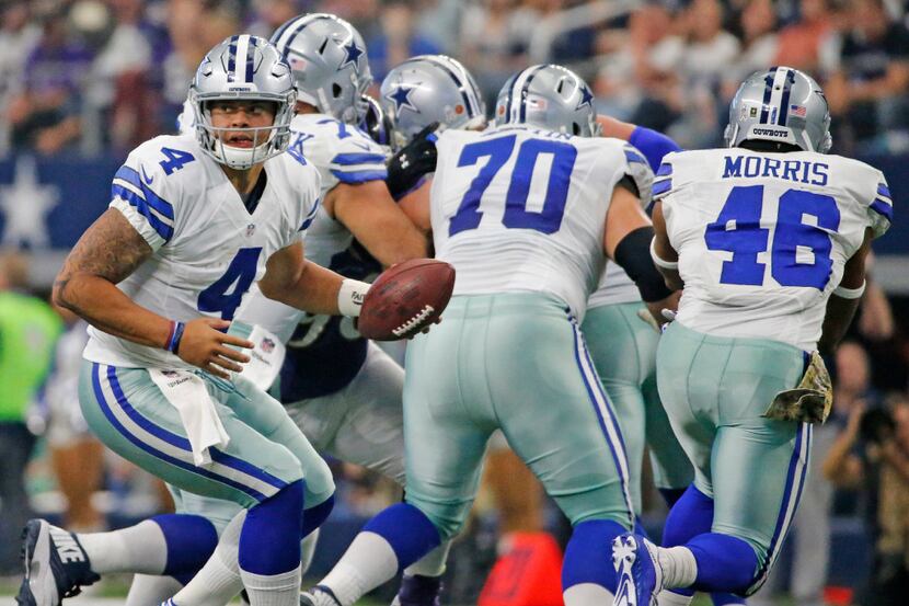 Dallas Cowboys quarterback Dak Prescott (4) is pictured behind a wall of blockers during the...