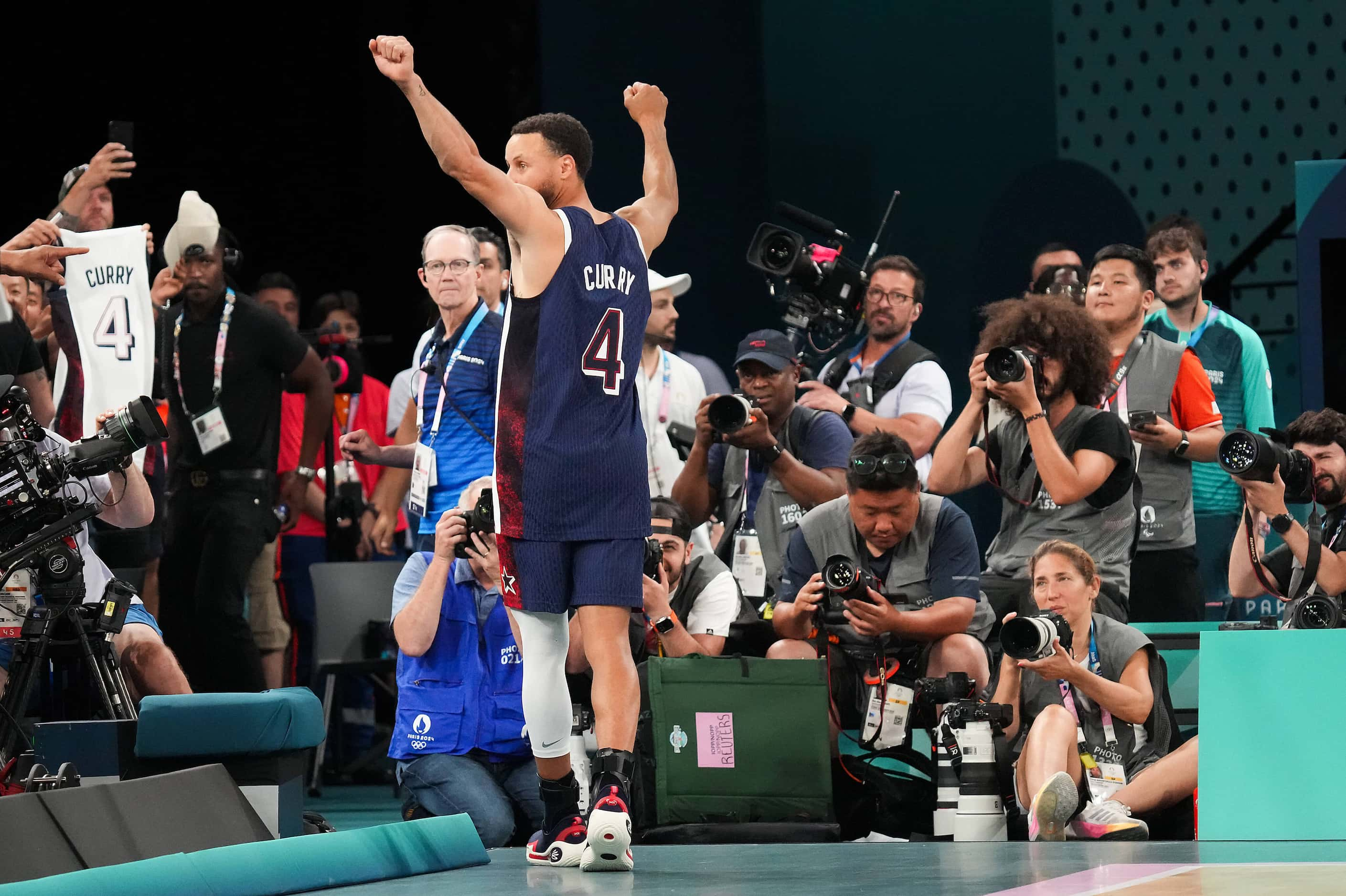 Stephen Curry (4) of the United States celebrates as he leaves the court after a victory...