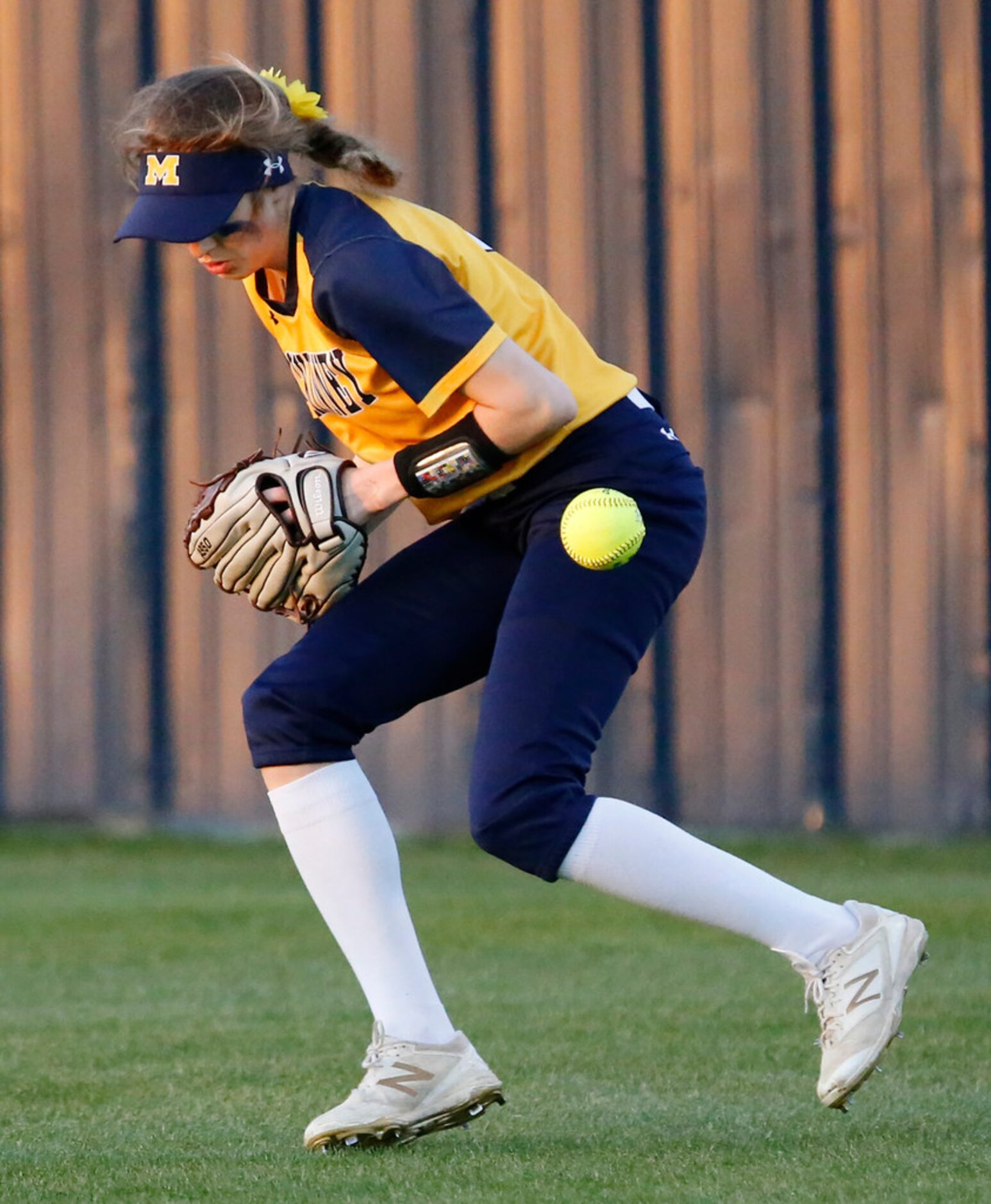 McKinney High School center fielder Taylor Bouck (3) mishandles a hit during the second...