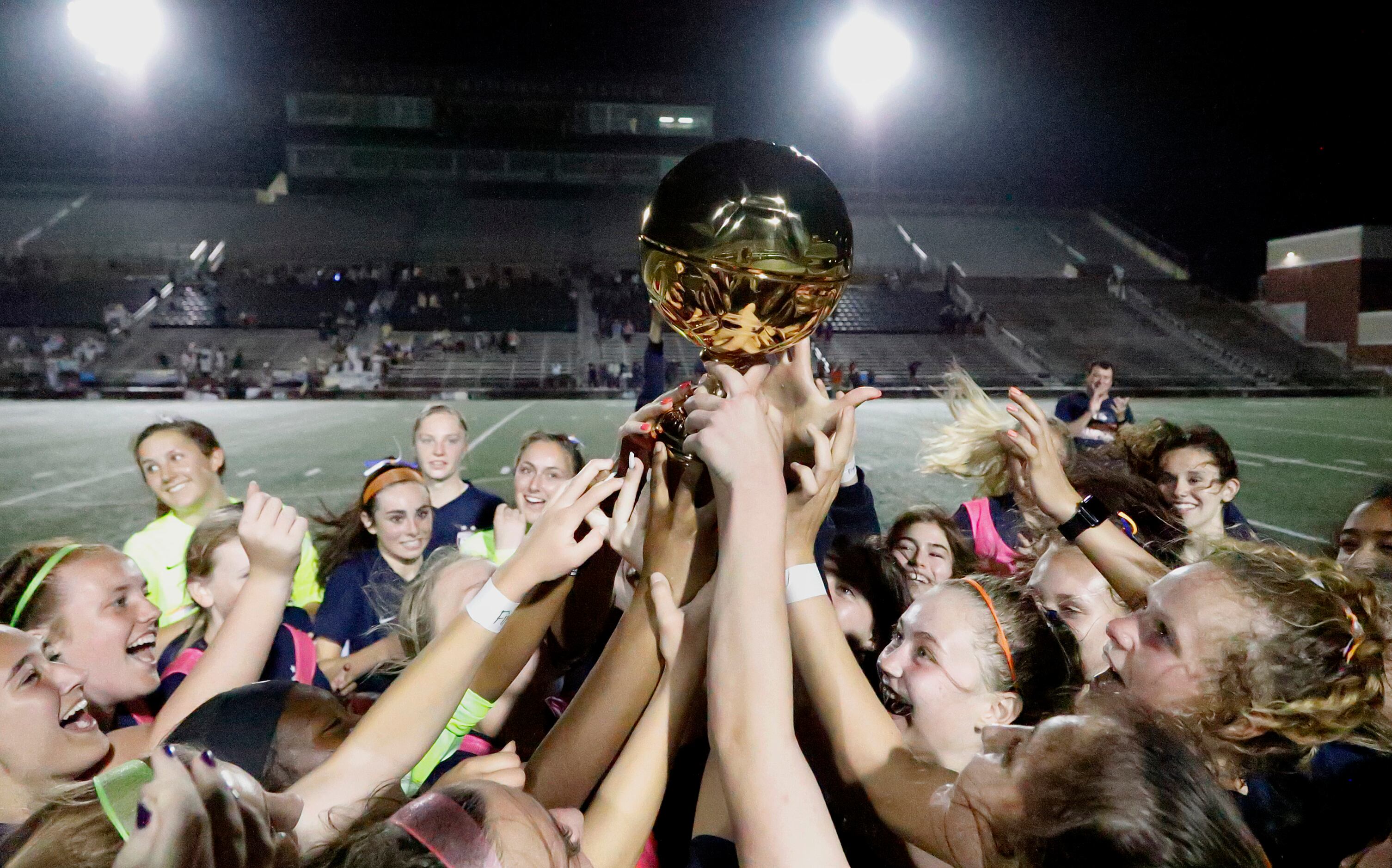 Wakeland hoists the trophy after defeating Highland Park in two overtimes as Wakeland High...