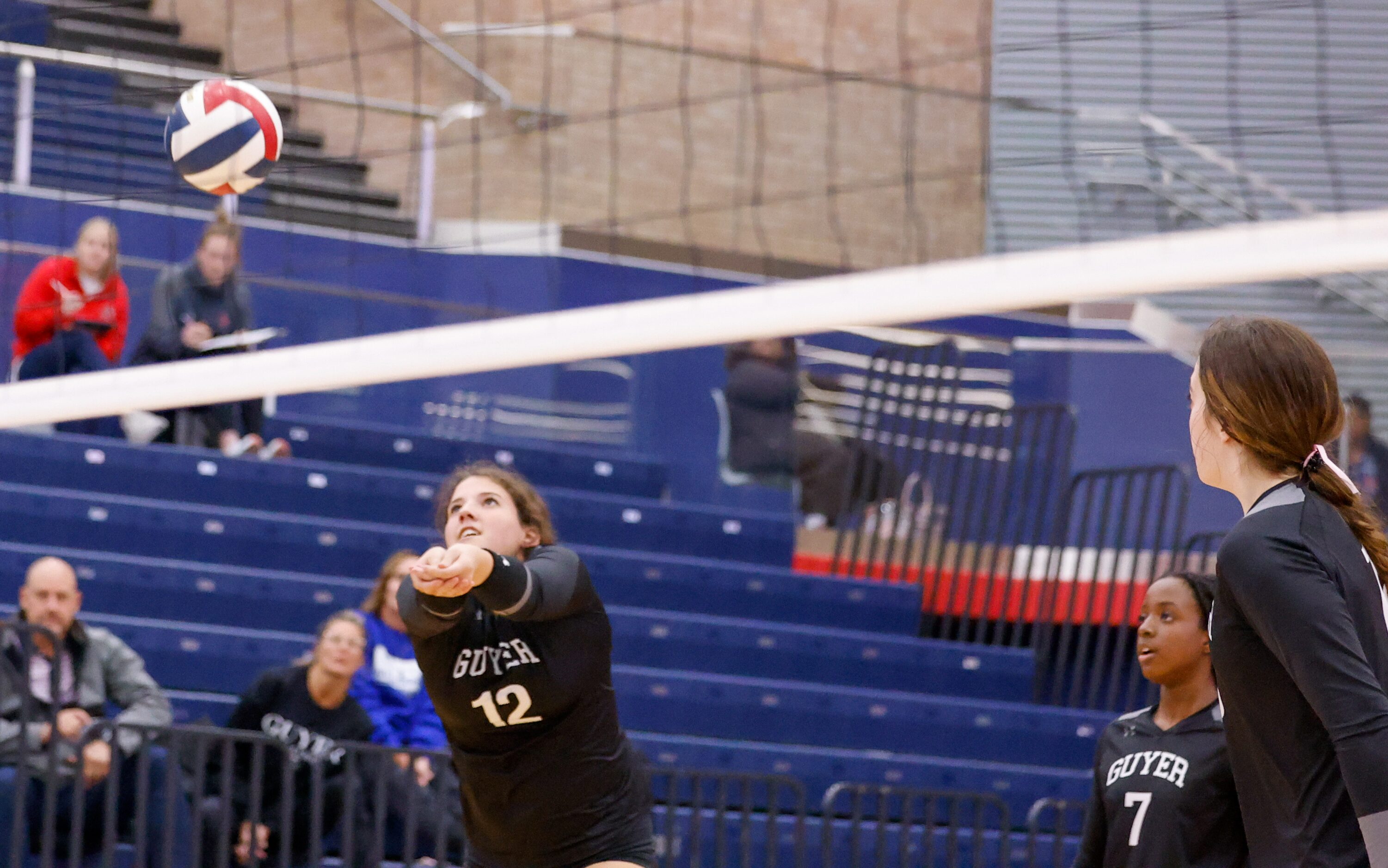 Denton Guyer senior Hayden Brock (12) prepares to volley the ball in the beginning of a play...