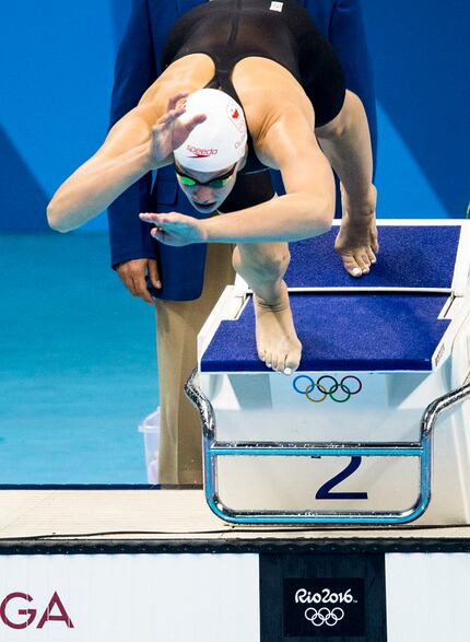 Penny Oleksiak of Canada dives into the start of the women's 100m butterfly finals at the...