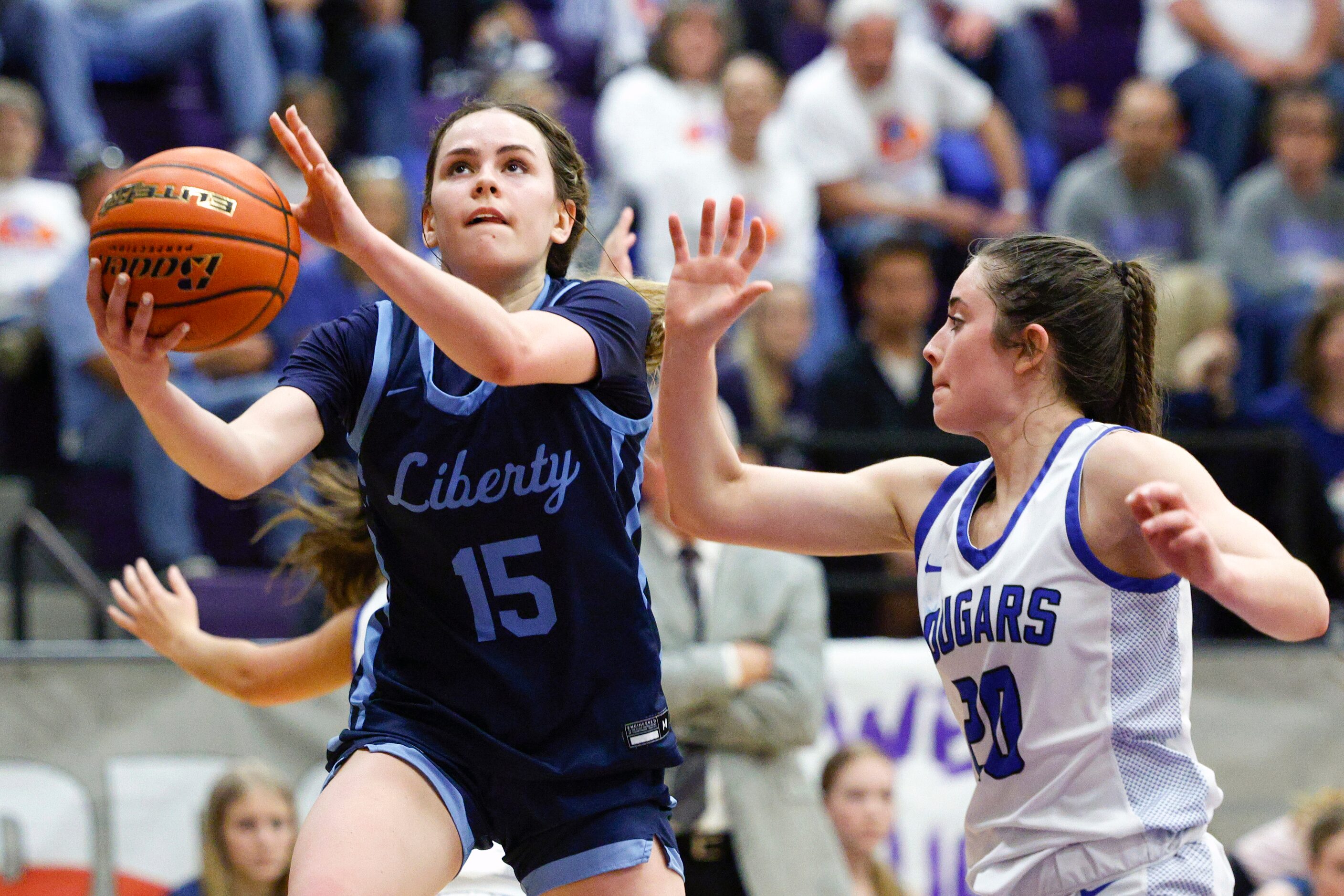 Argyle Liberty Christian guard Emma Martin (15) attempts a layup ahead of Tyler Grace...