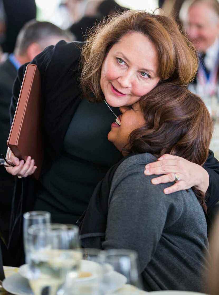 
First Lady of Texas Cecilia Phalen Abbott, left, hugs Texas Medal of Arts Award honoree...