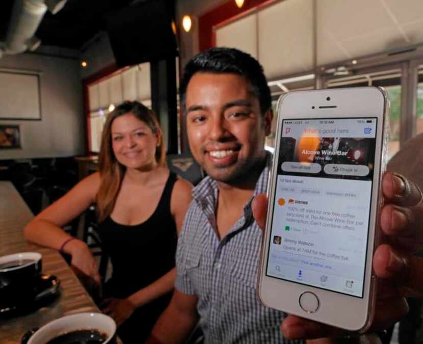 
Stephanie Campos (left) and Marty Martinez used the Foursquare app on Martinez’s smartphone...