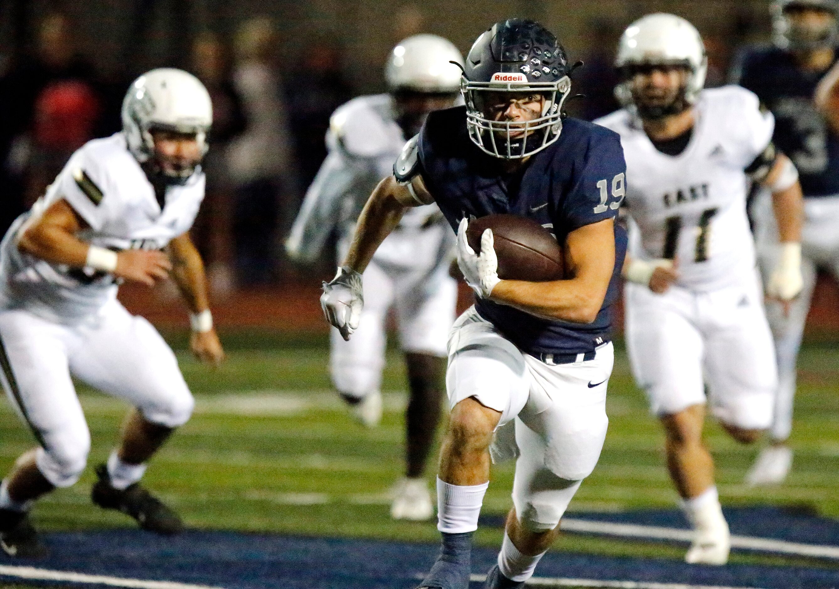 Flower Mound High School running back Cade Edlein (19) breaks off a long run during the...