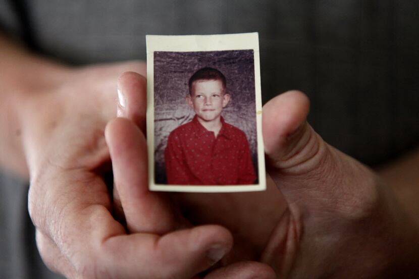 Gary Morrow holds a photograph of himself at ten years old, one year younger than the age he...