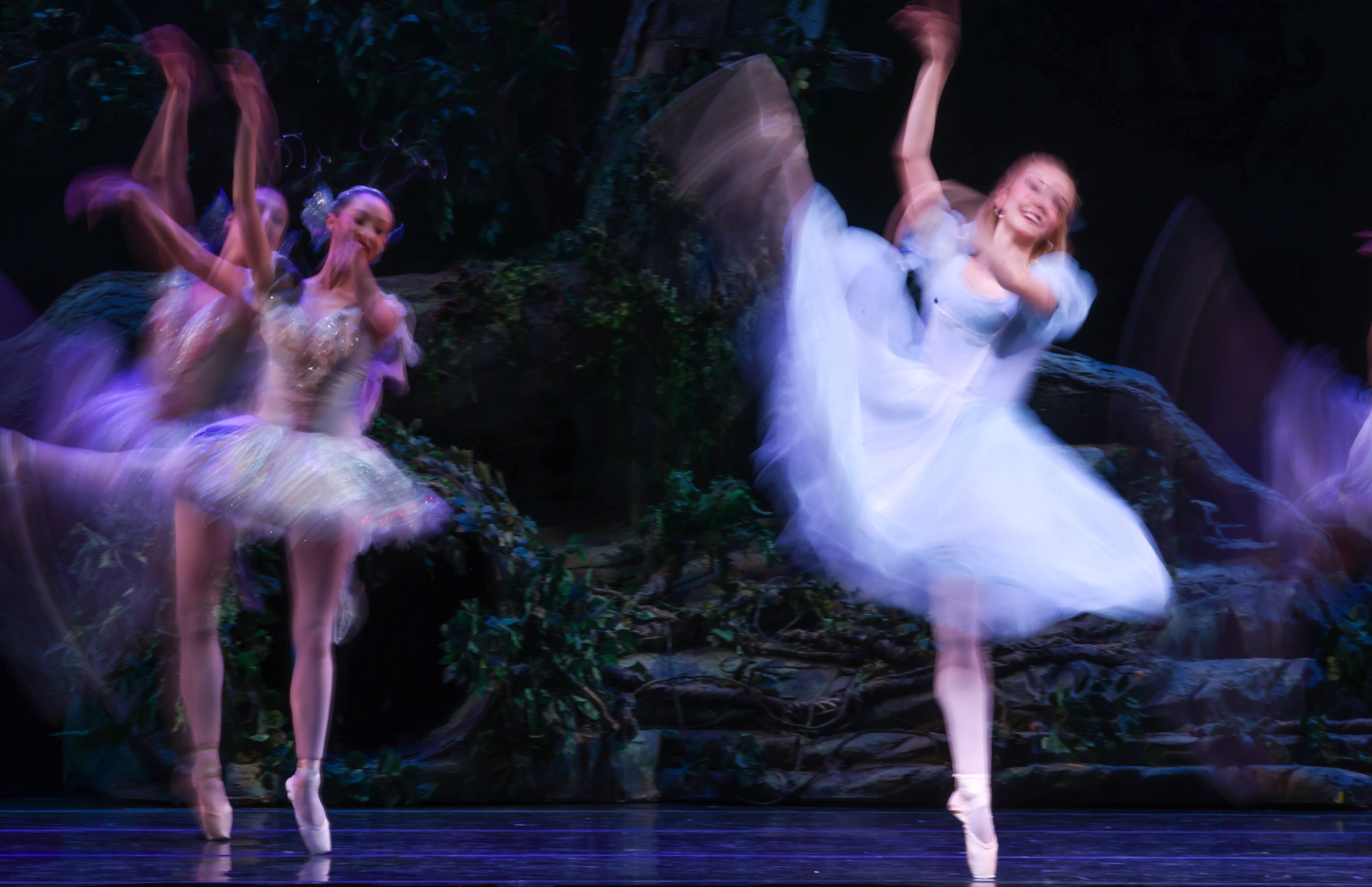 Alice (Alexandra F. Light, center) dances with a swarm of butterflies and dragonflies after...