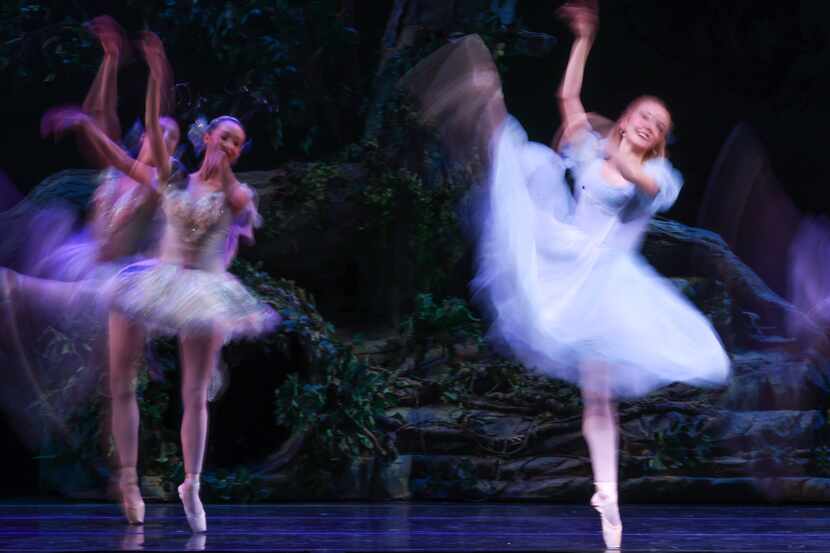 Alice (Alexandra F. Light, center) dances with a swarm of butterflies and dragonflies after...