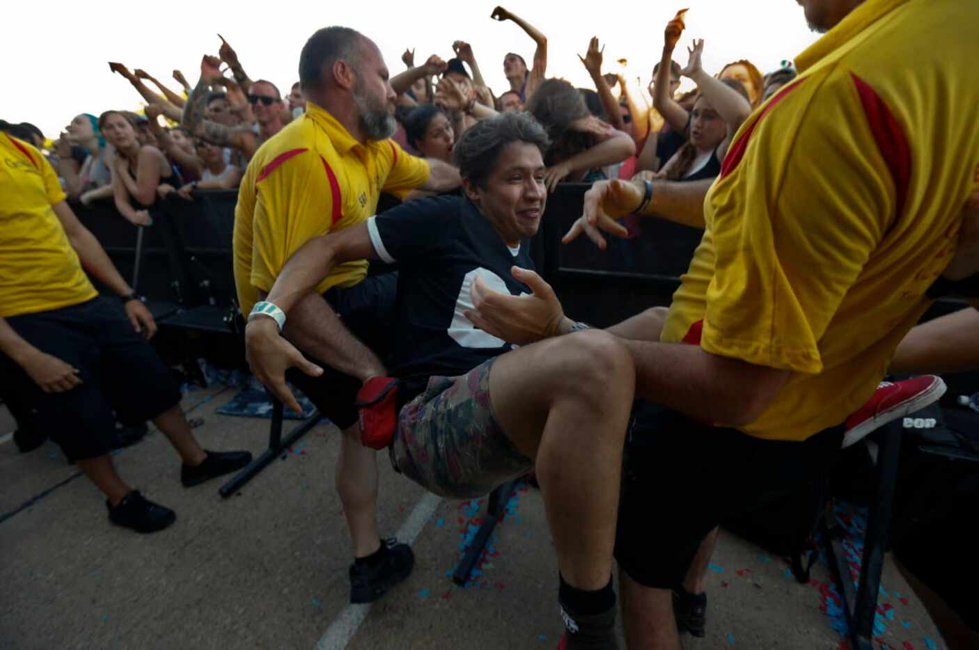 Victor Lopez lands after crowd surfing during Vans Warped Tour at Gexa Energy Pavilion in...