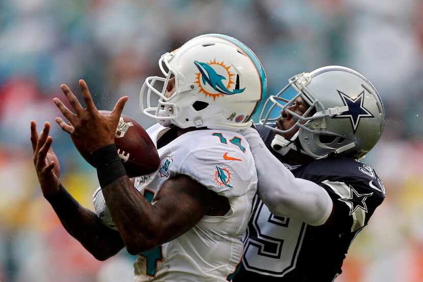 Dallas Cowboys cornerback Brandon Carr (39) breaks up a pass meant for Miami Dolphins wide...