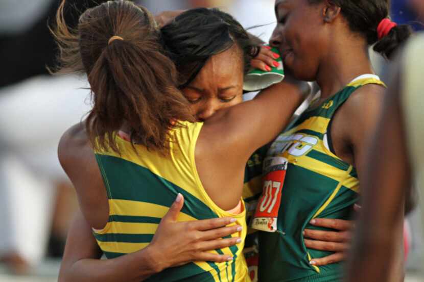 Hugs were all around among the DeSoto girls team after its victory in the 4x400-meter relay...